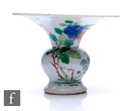 A Chinese enamelled (Daoguang period 1821-50) spitoon vase, of baluster form rising to a flared rim, decorated with flowering