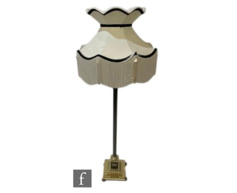 A mid 20th Century French Empire style ebonised and brass standard lamp and shade, on a square gadrooned base and paw feet, h