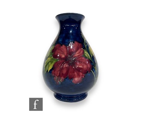 A post war Moorcroft Pottery vase by Walter Moorcroft, of footed ovoid form with waisted collar neck, tube line decorated in 