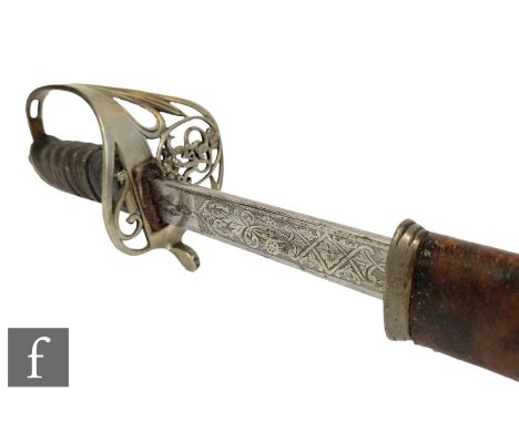 A George V artillery officer's dress sword, pierced brass guard and fish skin grip with leather scabbard, length 83cm. 