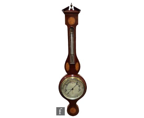 An Edwardian string inlaid and fan paterae decorated aneroid barometer, silver circular dial, chequer strung border, height 9