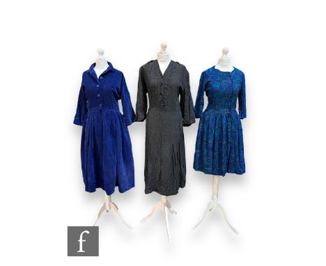 Three lady's vintage dresses comprising a three quarter sleeve cotton midi dress with geometric abstract motifs in tones of b