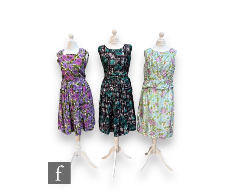 Three 1950s/60s lady's vintage sleeveless dresses, comprising a pale blue midi dress with stylised purple, white and pink flo