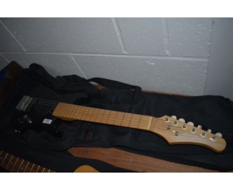 A childs electric guitar with battery powered speaker built in, with Stagg carry case