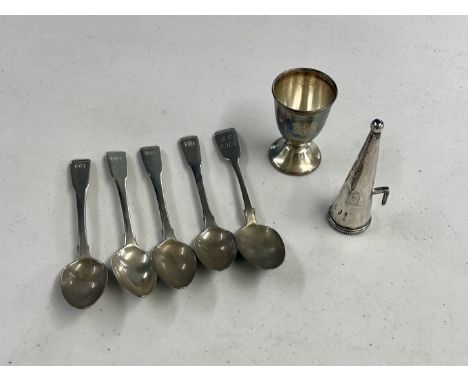 An Irish silver candle snuffer (hallmarks rubbed), a silver egg cup and a set of four silver spoons with an odd spoon, total 