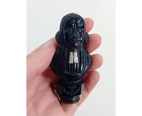 A jet seal carved in the form of the Reverend George Whitefield, with mother of pearl detail, marked on reverse 'Centenary 18