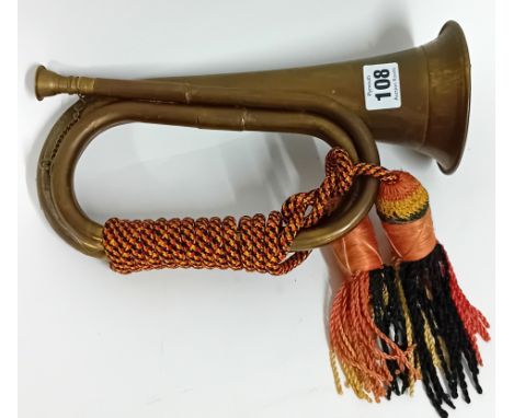 A brass Royal Artillery bugle, with red yellow and black bugle knot, length 27.5cm.Sold on behalf of the Samaritans of Plymou