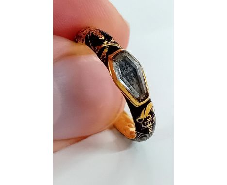 A George I gold and black enamel skeleton memento mori ring, with raised coffin paste stone concealing a skeleton, and decora