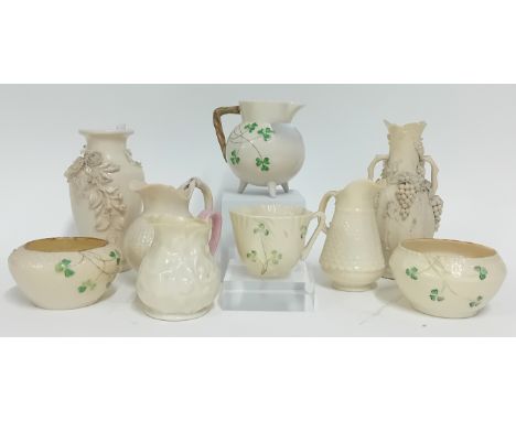 A collection of Belleek pottery, to include a painted clover jug, teacup, and vases, a pair of basket vases, splayed leaf des