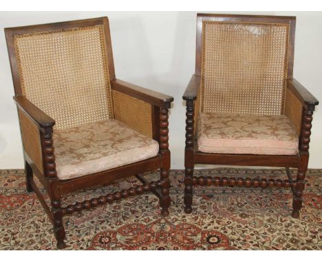 A set of four early 20th century indigenous hardwood and cane Bergere chairs, raised on bobbin turned supports with squab cus