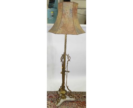 An early 20th century French gilt brass and metal standard lamp, having spiral turned column with acanthus leaf capped and sc
