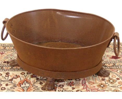 A contemporary rusted iron circular twin handled trough planter, length 58cm