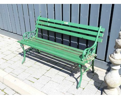 A green painted pierced metal ended and wood slatted two-seater garden bench, w.122cm 