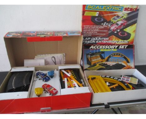 A boxed "Super Saloons" Scalextric set along with C221 accessory set and lap counter extension pack