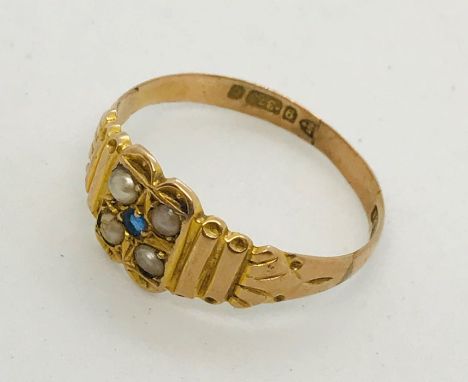 A Victorian 9ct gold ring set with a sapphire and seed pearls.