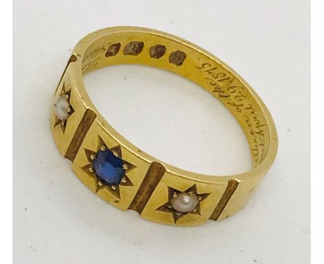 A Victorian 18ct gold ring set with a sapphire and seed pearls. Weight 4.3g
