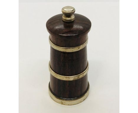 A silver banded pepper grinder 