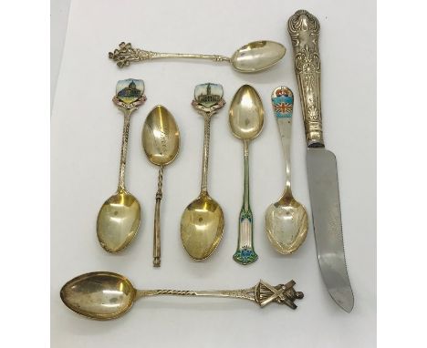 A small collection of hallmarked silver and enamel teaspoons along with a silver handled knife 