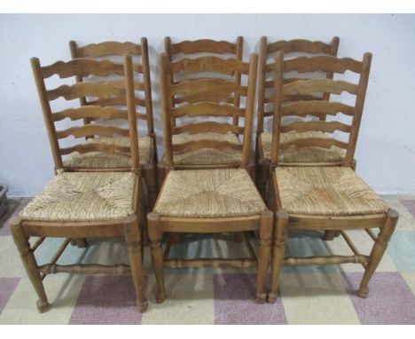 A set of six rush seated ladder back chairs 