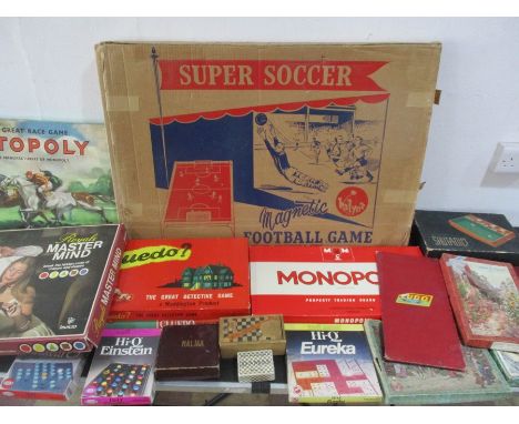 A collection of various vintage board games and jigsaw puzzles including super soccer, chess, Cluedo, Totopoly, Monopoly etc