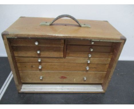 An oak tool box with 8 drawers