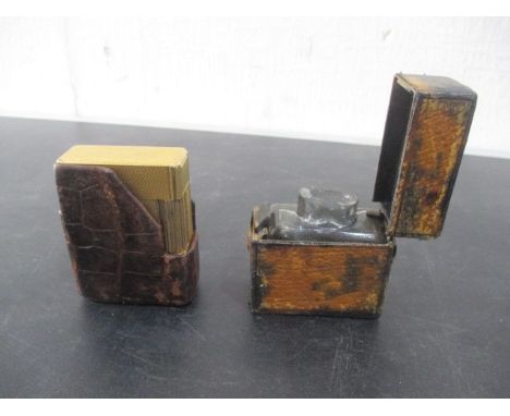 A gold plated Dupont lighter in leather case, along with travelling inkwell 