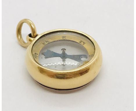 An unmarked gold compass.