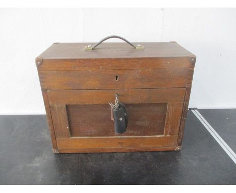 A vintage wooden toolbox with various tools and accessories including spanners, drill bits etc