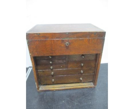 An oak tool box with 7 drawers