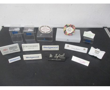 A collection of point of sale display signs including Wedgwood, John Beswick, Royal Crown Derby, Caithness, Portmeirion, Wade