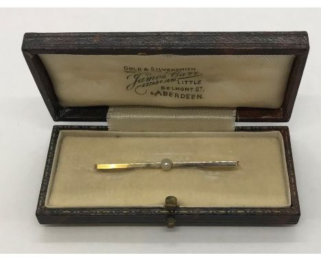 A 9ct gold bar brooch set with a seed pearl. Weight 1.7g