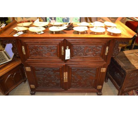 A 20th century Chinese hardwood sideboard, having altar style top with scroll ends, stylized Greek key ends, over carved deep