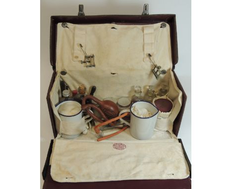 A c.1930's Midwifes case and contents by James Woolley Sons, Manchester.  The black leather rectangular case with original wh