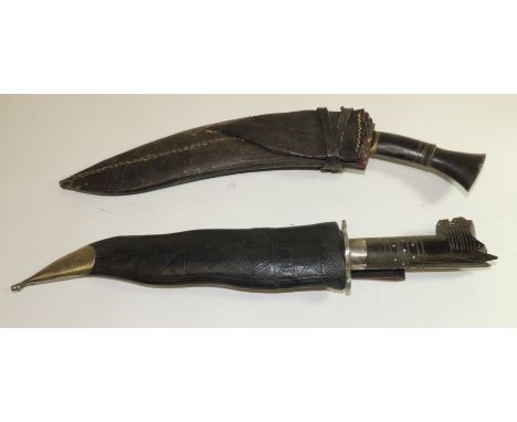 A souvenir Kukri with horn handle and in leather scabbard and an Indian souvenir kris with carved horn handle and in leather 