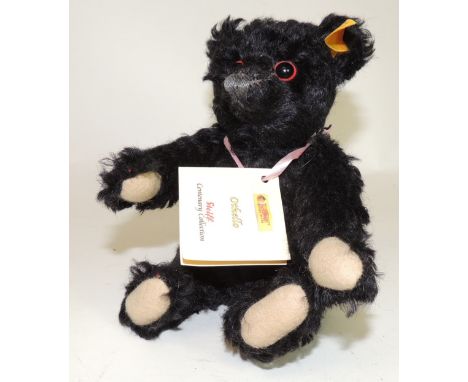 A modern Steiff "Othello" black teddy bear (replica of the "mourning" bear sold after the Titanic disaster 1912), 20cms high,