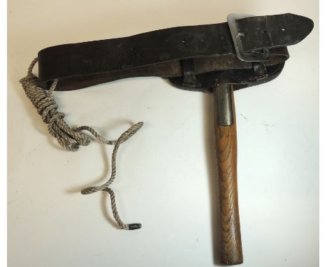 An early 20th Century firemans axe with wood shaft, in leather pouch on leather belt with belt line, the wood shaft stamped w