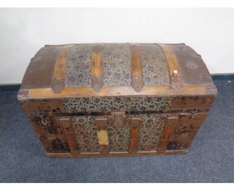 A late 19th century wooden bound tooled leather dome topped shipping trunk   