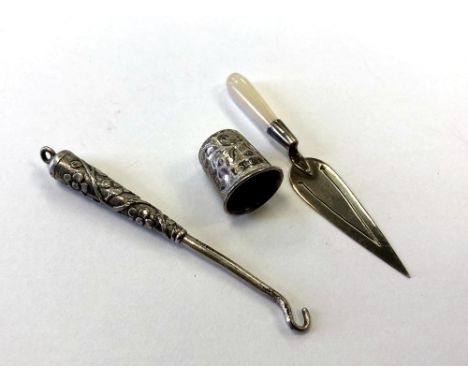 A silver thimble, a page marker and a Chinese button hook