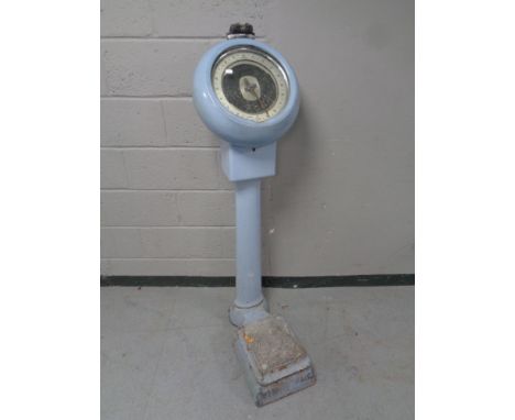 A set of early twentieth century enamel coin operated scales 