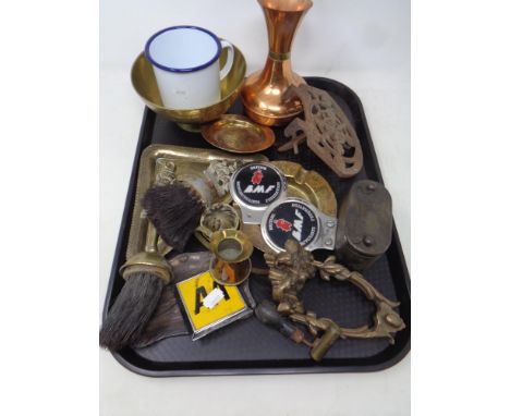 A tray of antique and later cast iron and brass, vintage car and motorcycle badges, money box, enamel mug etc 
