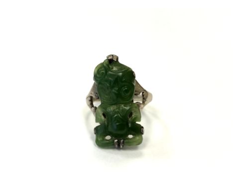 A silver and jade hei tiki ring