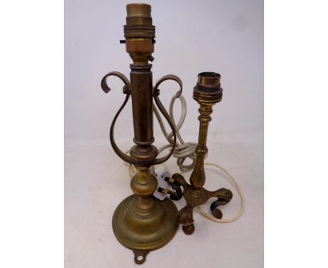 An antique brass ships candlestick together with a further brass railway style lamp
