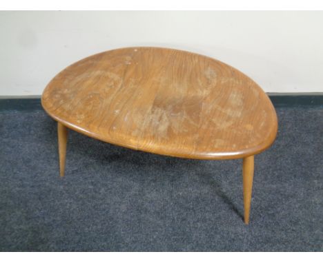 An Ercol elm and beech pebble table 