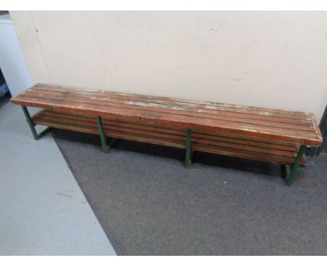 A twentieth century iron wooden slatted bench with shelf, length 214 cm
