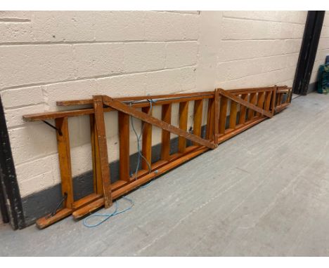 An early twentieth century wooden folding ladder by Slingsby-ladders, length 394 cm.