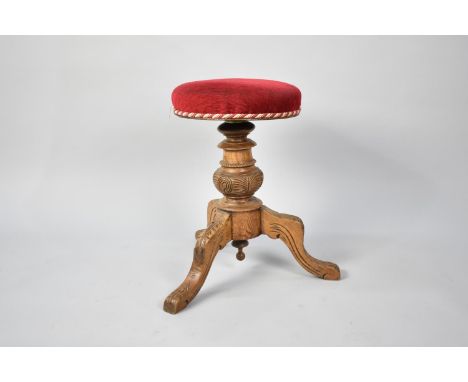 A Late Victorian/Edwardian Swivel Top Piano Stool on Carved Wooden Tripod Base 