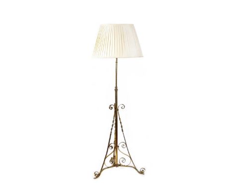 VICTORIAN BRASS STANDARD LAMP AND SHADE WITH SCROLLED SUPPORTS.RAISED ON THREE SCROLLED LEGS.HEIGHT: 67 INCHES.IN GOOD CONDIT