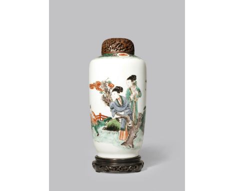 A CHINESE FAMILLE VERTE CYLINDRICAL VASE KANGXI 1662-1722 The body painted with two ladies and two boys at play in a fenced g