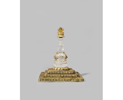 A NEPALESE ROCK CRYSTAL AND GILT COPPER MODEL OF A STUPA 18TH/19TH CENTURY The crystal pillar mounted with a gilt copper fini