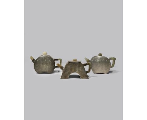 THREE CHINESE INSCRIBED PEWTER-ENCASED YIXING TEAPOTS AND COVERS QING DYNASTY One coin-shaped, two moon-shaped, all set with 